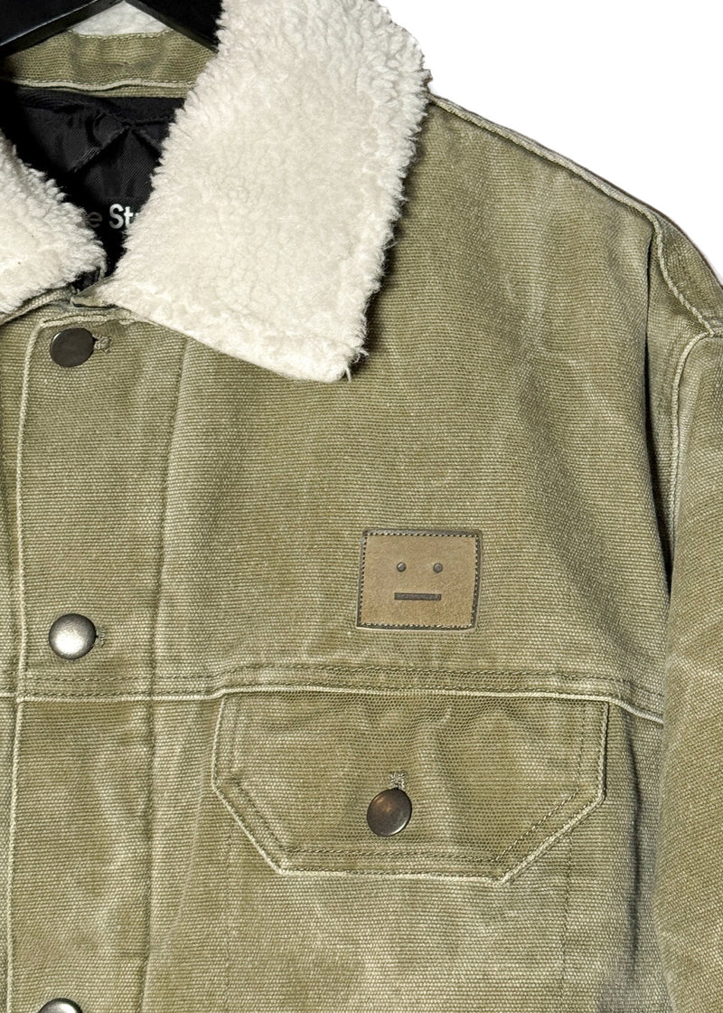 Upper body of of Acne Studios Green Canvas Faux Shearling Orsan Trucker Jacket