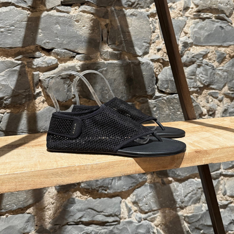 Main photo of Alaïa Black Fishnet Mesh Thong Sandals