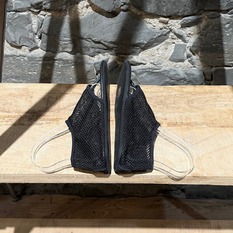 Side-by-side view of Alaïa Black Fishnet Mesh Thong Sandals