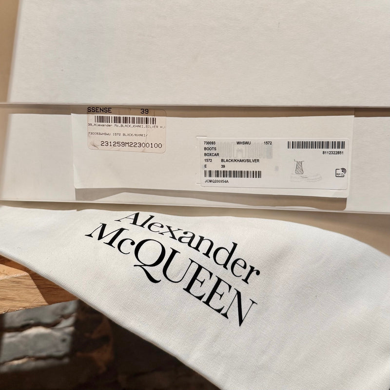 Box and branded dustbag of Alexander McQueen Black Leather Khaki Tread Slick Chelsea Boots