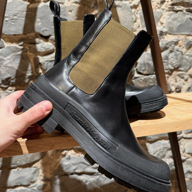 Close-up on Alexander McQueen Black Leather Khaki Tread Slick Chelsea Boots