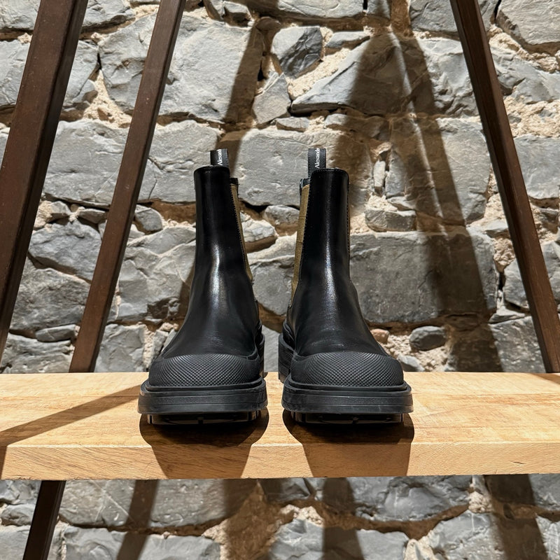 Front view of Alexander McQueen Black Leather Khaki Tread Slick Chelsea Boots