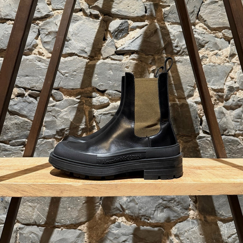 A side view of Alexander McQueen Black Leather Khaki Tread Slick Chelsea Boots
