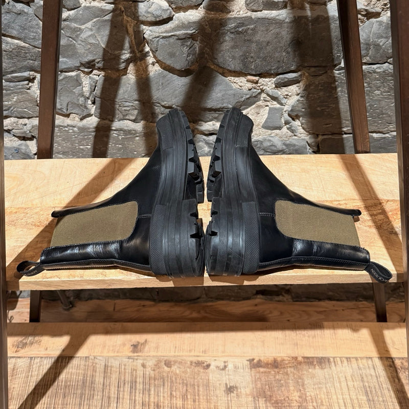 Side-by-side view of Alexander McQueen Black Leather Khaki Tread Slick Chelsea Boots