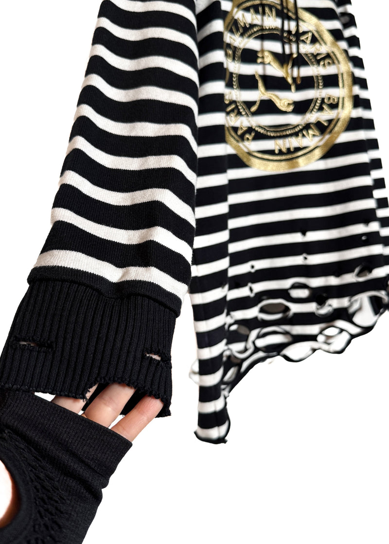 A sleeve and cuff of Balmain X Puma Black Striped Embroidered Distressed Hoodie Sweater