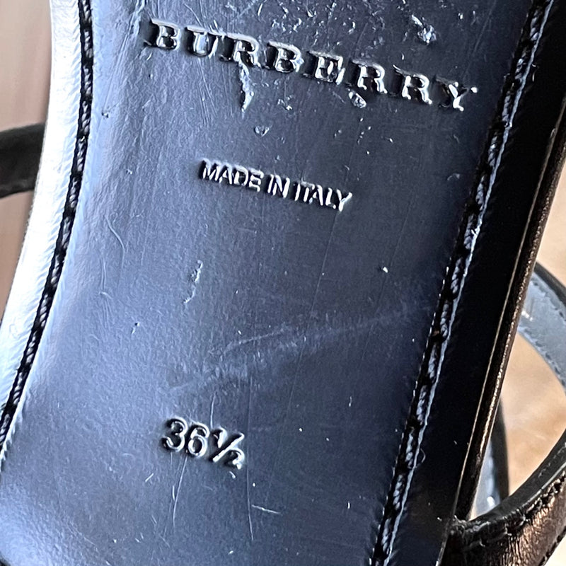 Band, origin and size stamps on one outsole of Burberry Black Leather Clasp Accent Thong Sandals