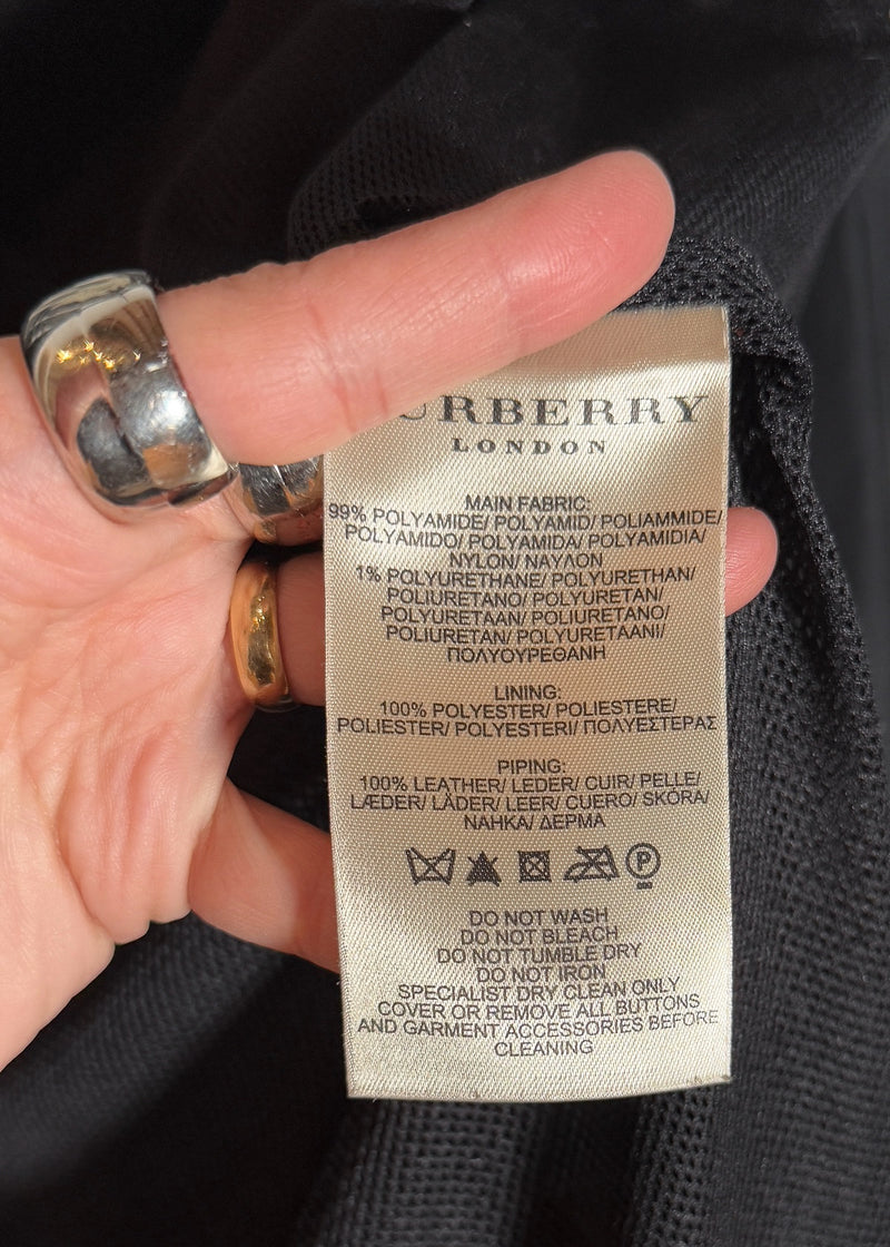 Material and care label of Burberry Black Nylon Patent Piping Trench Coat