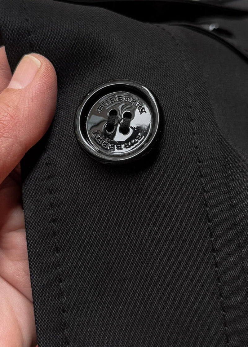 A branded button of Burberry Black Polyester Satin Mabeldon Trench Coat