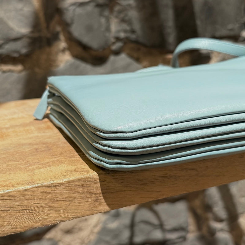 A bottom corner view of Céline Light Blue Small Trio Crossbody Bag