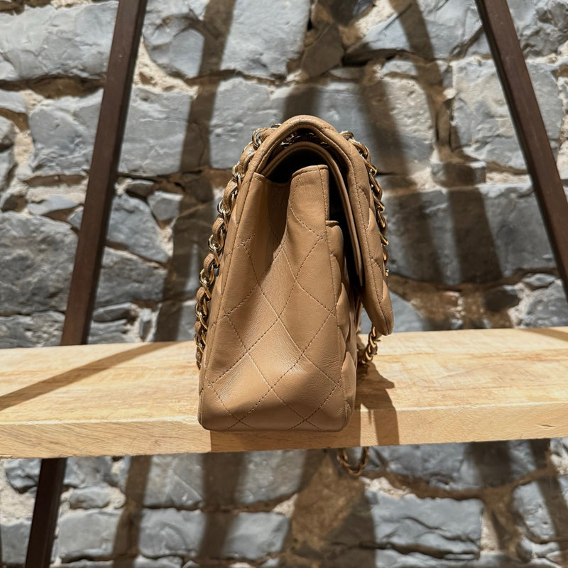 A side view of Chanel 2013-2014 Beige Lambskin Jumbo Classic Double Flap Bag