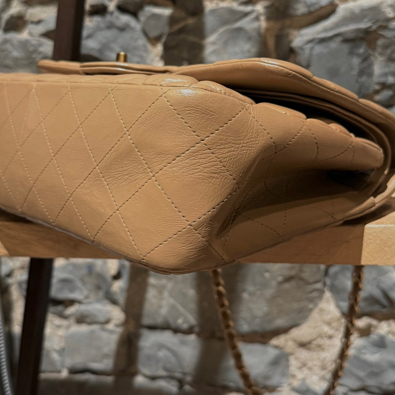 A bottom corner view of Chanel 2013-2014 Beige Lambskin Jumbo Classic Double Flap Bag