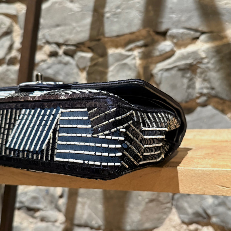 A bottom corner of Chanel 2015-2016 Navy Blue Satin Sequin Beaded Medium Double Flap Bag