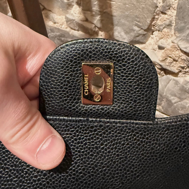 Branded hardware of Chanel Black Caviar Jumbo GHW Classic Double Flap Bag