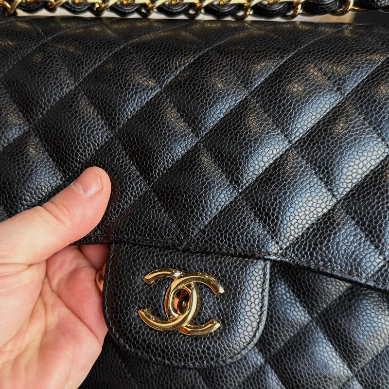 Logo hardware of Chanel Black Caviar Jumbo GHW Classic Double Flap Bag