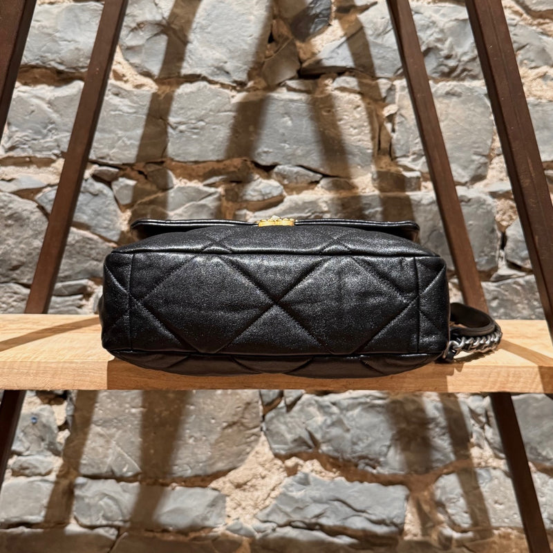 Chanel 2019 Large 19 Chain Flap Bag in black shiny calfskin leather with diamond quilted stitching. Features a mixed-metal chain strap with intertwined leather, a gold-tone CC logo turn-lock closure, and a back slip pocket with a snap button closure. The interior is lined in red fabric with a zip pocket and a gold-tone Chanel logo plaque.