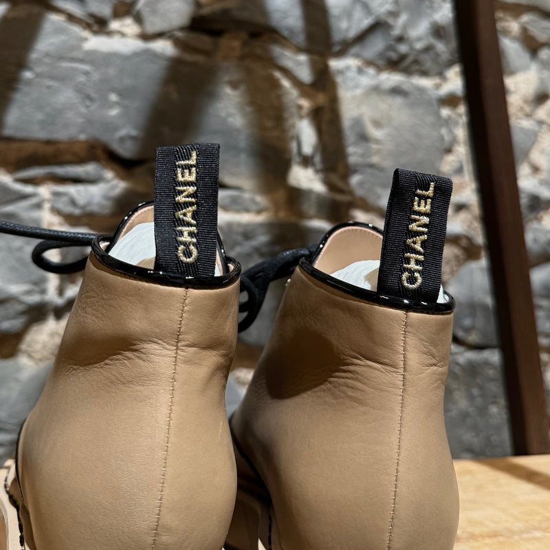 Branded pull tabs of Chanel 2020 Beige Leather CC Patent Cap Toe Combat Boots