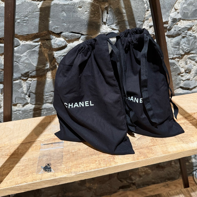 Branded dustbags of Chanel 2021 Black Leather CC Strappy Heeled Sandals