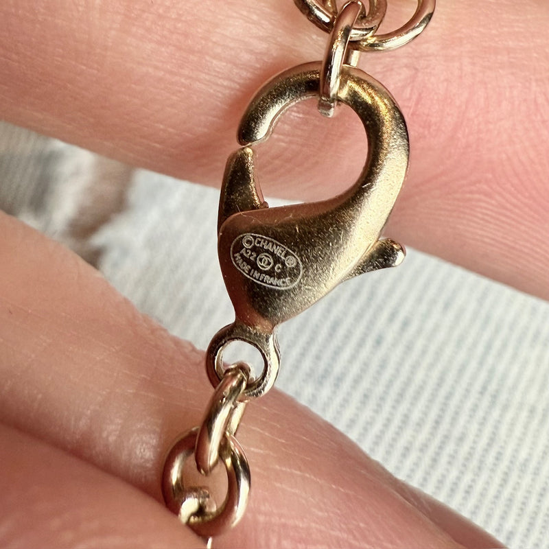 Engraved brand authenticity and origin on clasp of Chanel 22C Champagne Gold Crystals Pearls CC Chain Drop Necklace