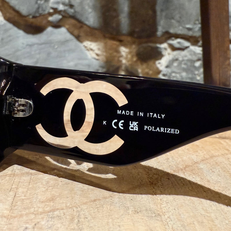 origin on branch of CC logo on branch of Chanel 5526 Black Acetate Clear CC Rectangular Sunglasses