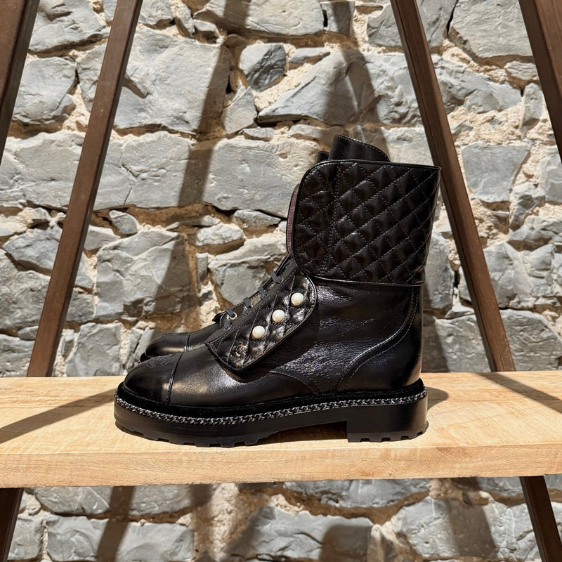 A side view of Chanel Back Glossy Pearl Chain Embellished Combat Boots