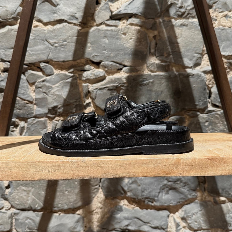 A side view of Chanel Black Caviar Leather CC Dad Slingback Sandals