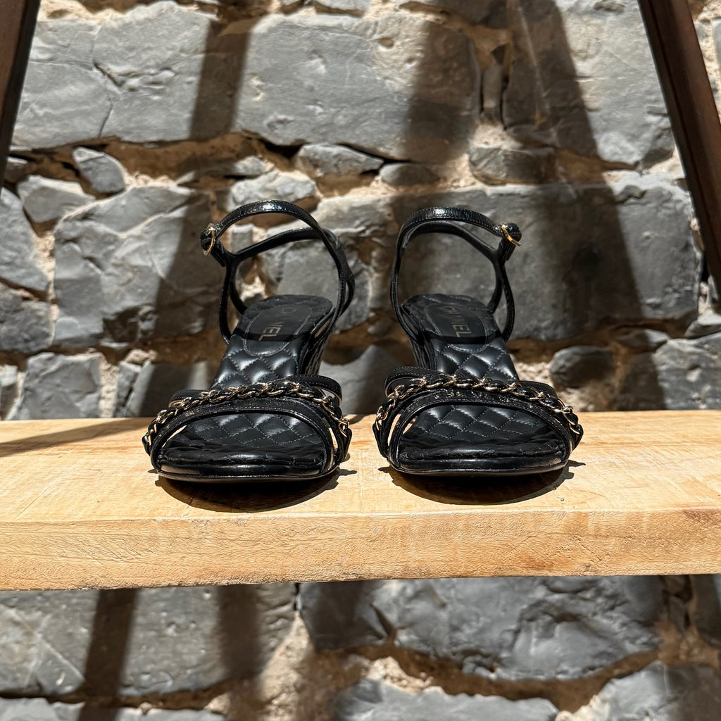 Front view of Chanel Black Crumpled Leather Chain Accent Quilted Wedge Sandals