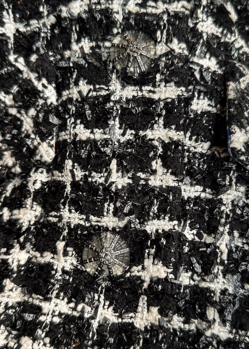 Close-up on fabric of Chanel SS20 Runway Black White Tweed Pink Accent Coat