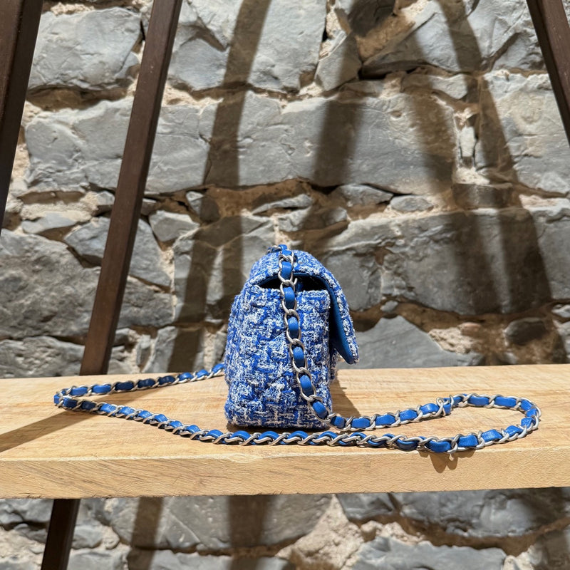 A side view of Chanel SS23 Blue White Tweed Rectangular Mini Classic Flap Bag