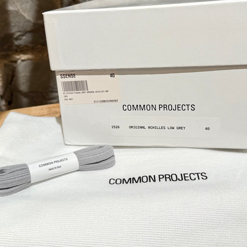 Packaging and spare laces of Common Project Grey Original Achilles Low Top Sneakers