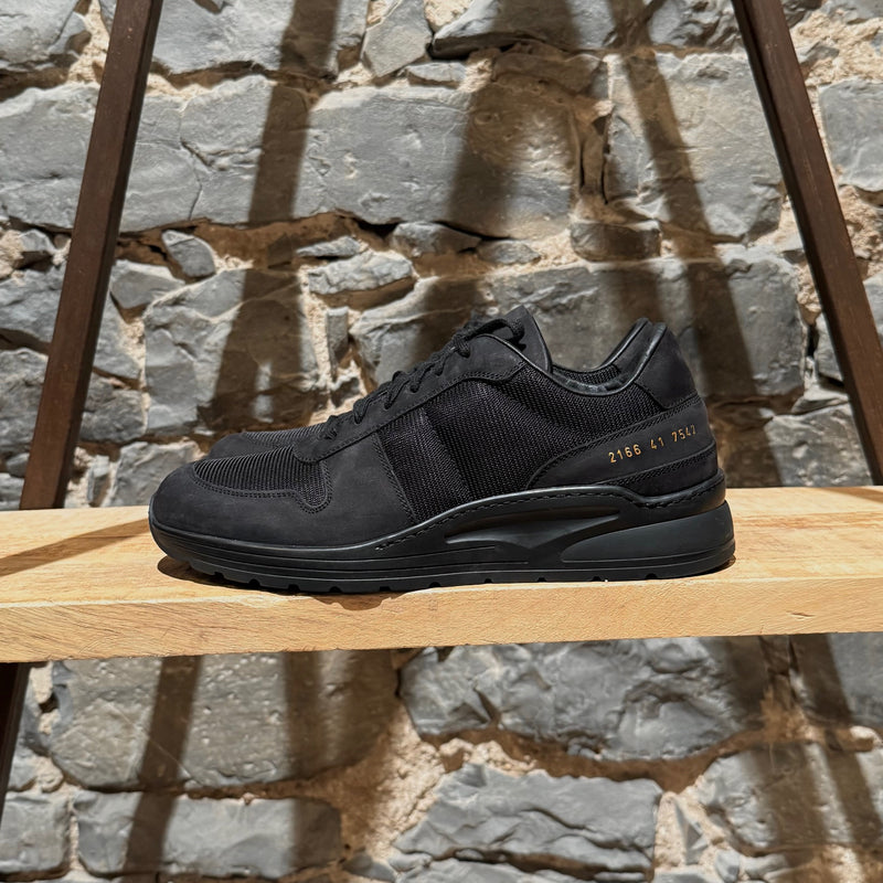 A side view of Common Project New Track Black Mesh Nubuck Sneakers