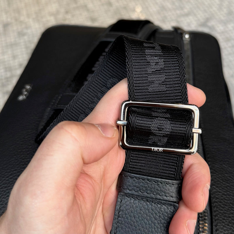 Branded hardware of Dior Black Grained Leather Maxi Safari Messenger Bag