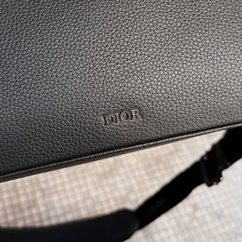 Brand detail on Dior Black Grained Leather Maxi Safari Messenger Bag