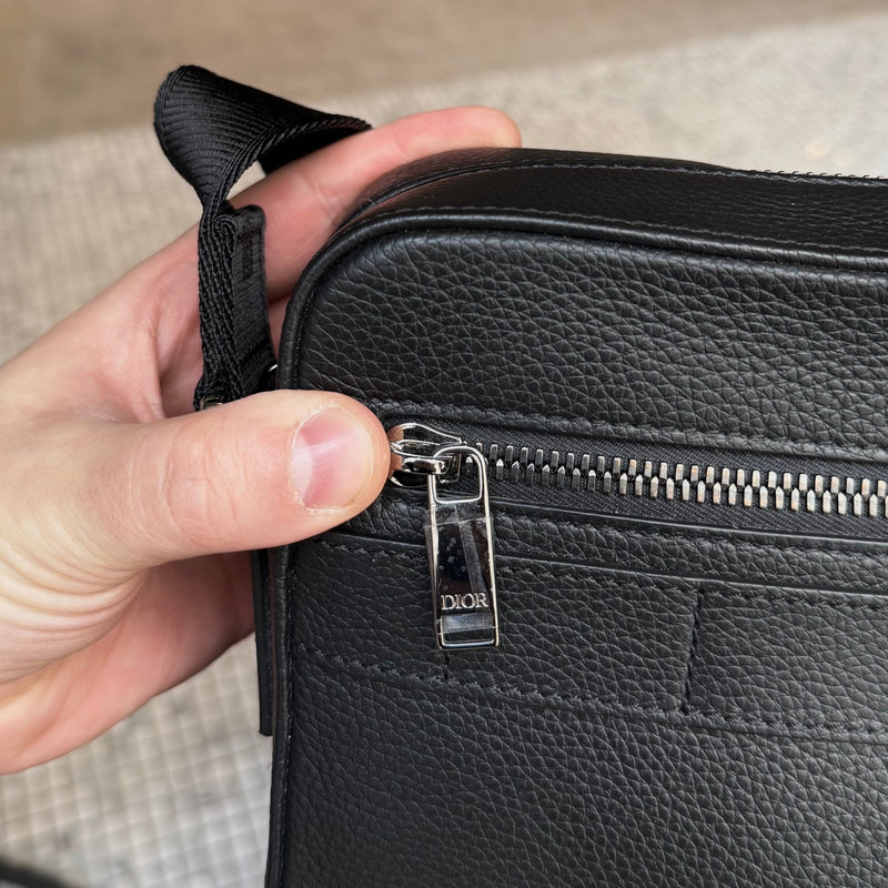 Branded hardware of Dior Black Grained Leather Maxi Safari Messenger Bag