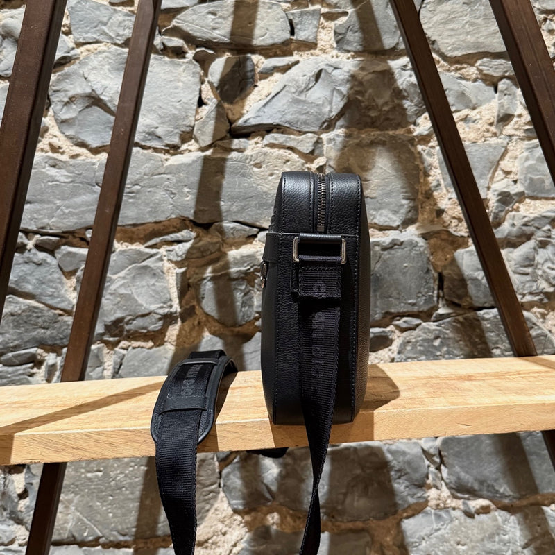 A side view of Dior Black Grained Leather Maxi Safari Messenger Bag