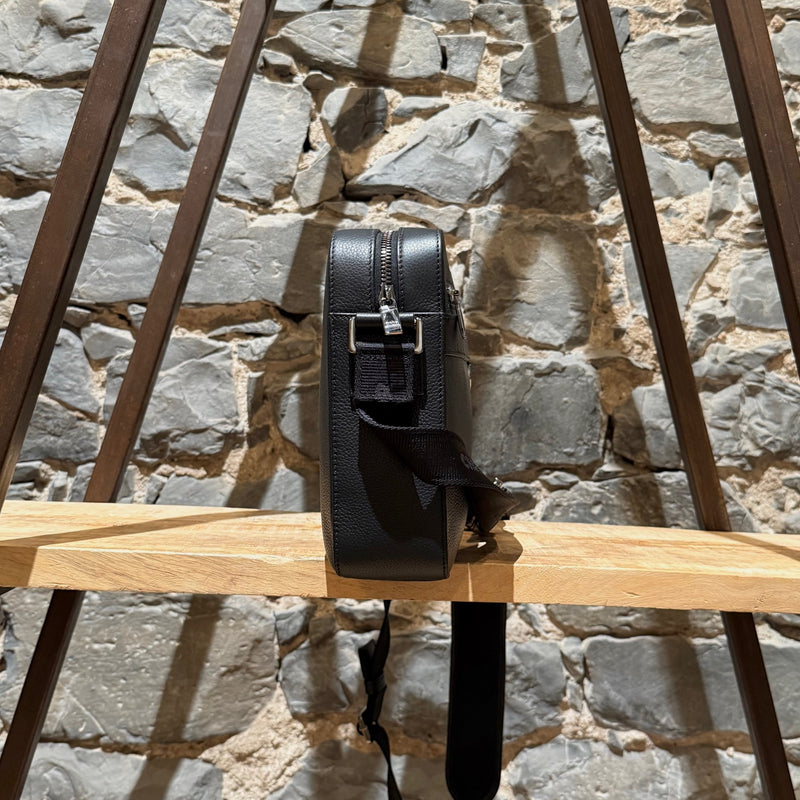 A side view of Dior Black Grained Leather Maxi Safari Messenger Bag