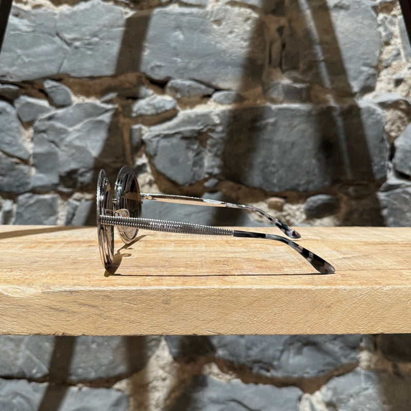 A side view of Dolce & Gabbana DG2179 Gold Round Metal Sunglasses