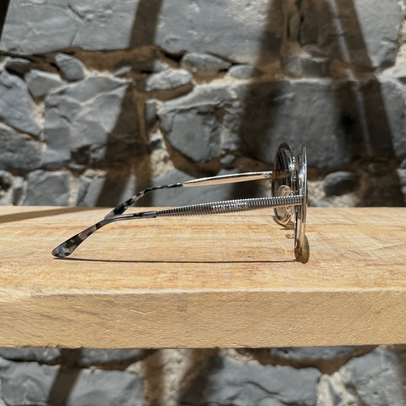 A side view of Dolce & Gabbana DG2179 Gold Round Metal Sunglasses