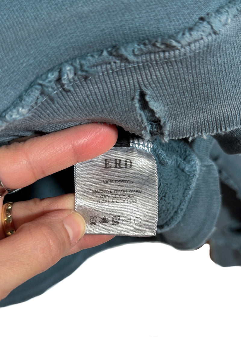 Material and care label of Enfants Riches Déprimés Distressed Washed Blue School Days Hoodie