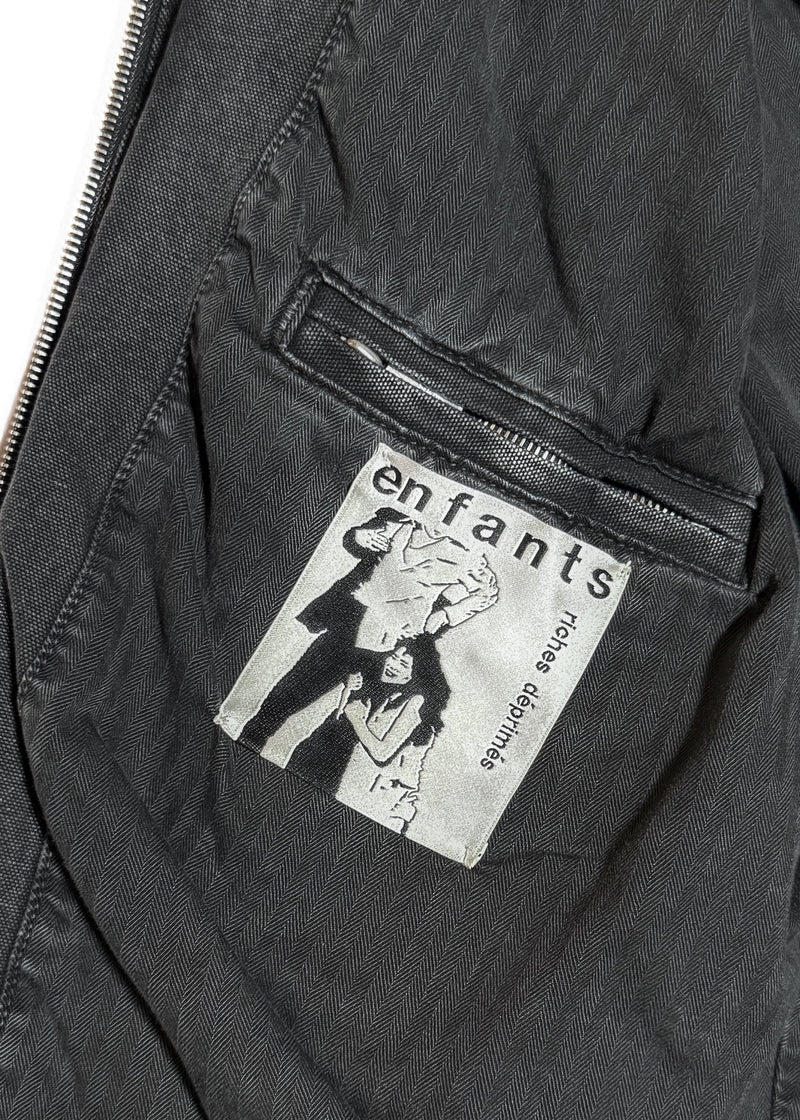 One pocket of Enfants Riches Déprimés FW23 Washed Black Italian Romance Denim Jacket