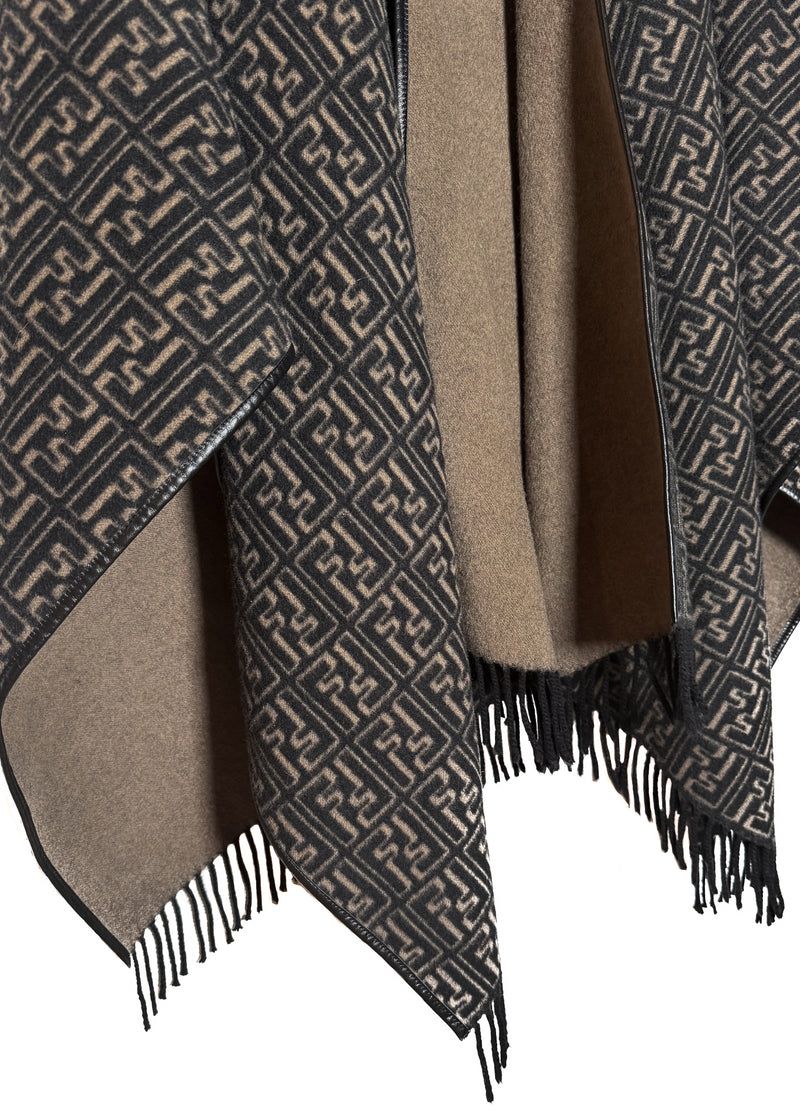 Fendi FF Monogram Leather Trim Wool Fringed Poncho displayed on a hanger. The poncho features an all-over FF monogram pattern in taupe and black, leather trim along the edges, and fringed hems. A silver-tone Fendi logo embellishment is visible at the back. Various images highlight the front, back, close-ups of the fabric, care label, and logo details.