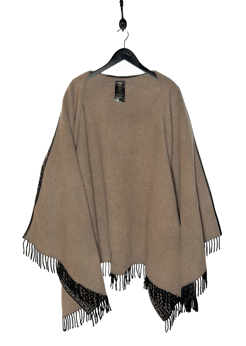 Fendi FF Monogram Leather Trim Wool Fringed Poncho displayed on a hanger. The poncho features an all-over FF monogram pattern in taupe and black, leather trim along the edges, and fringed hems. A silver-tone Fendi logo embellishment is visible at the back. Various images highlight the front, back, close-ups of the fabric, care label, and logo details.