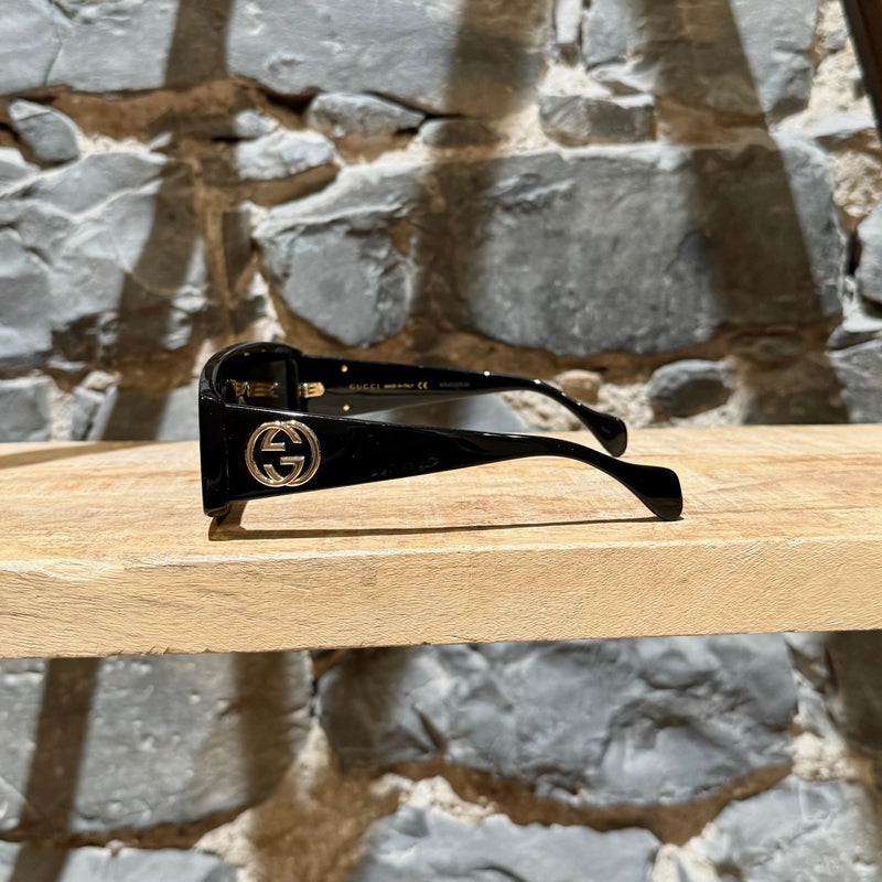 A side view of Gucci GG0358 Black Acetate Geometric Square GG Sunglasses