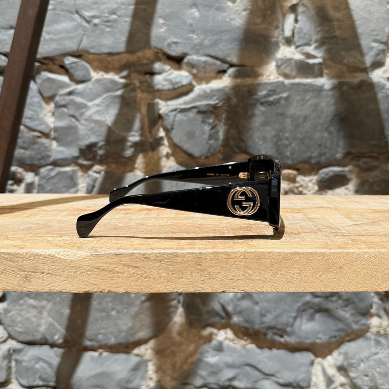 A side view of Gucci GG0358 Black Acetate Geometric Square GG Sunglasses
