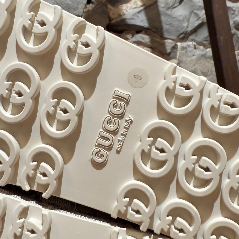 Brand and origin of Gucci Grey GG Logo Rubber Cubic Platform Slide Sandals