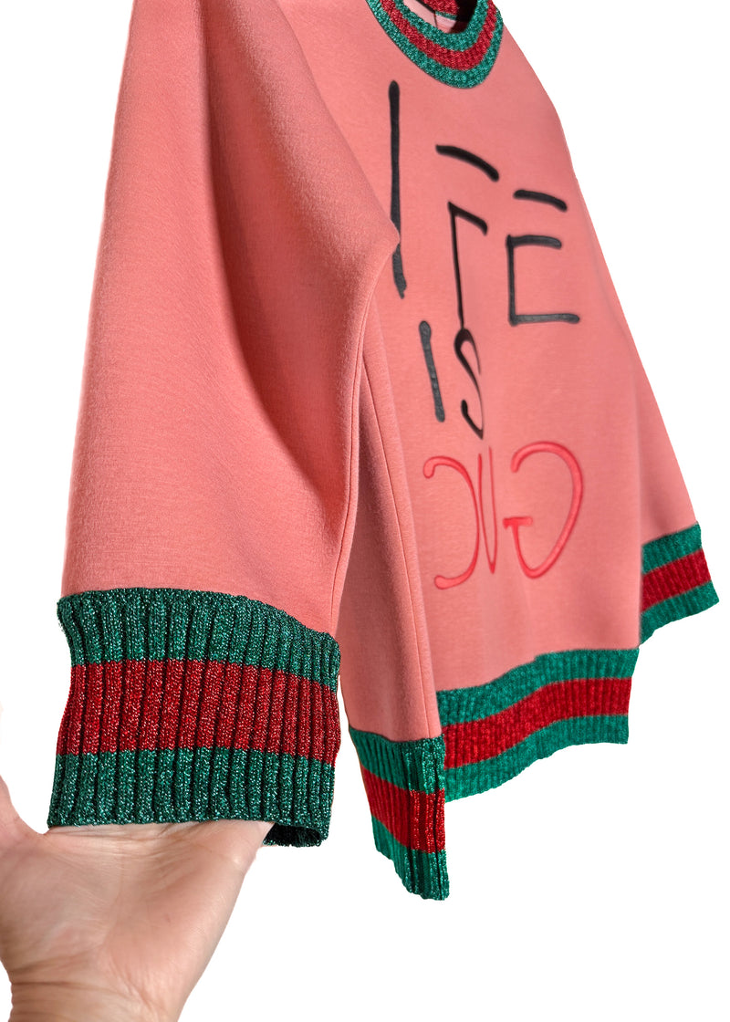 A sleeve and cuff of Gucci "Life Is Gucci" Ghost Pink Cotton Sweatshirt