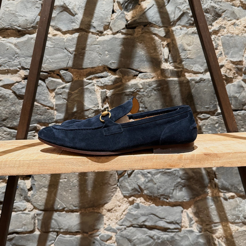 One side of Gucci Navy Blue Suede Horsebit Accent Jordaan Loafers