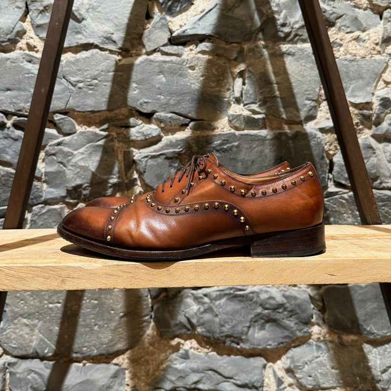 A side view of Gucci Studded Brown Leather Lace-up Shoes