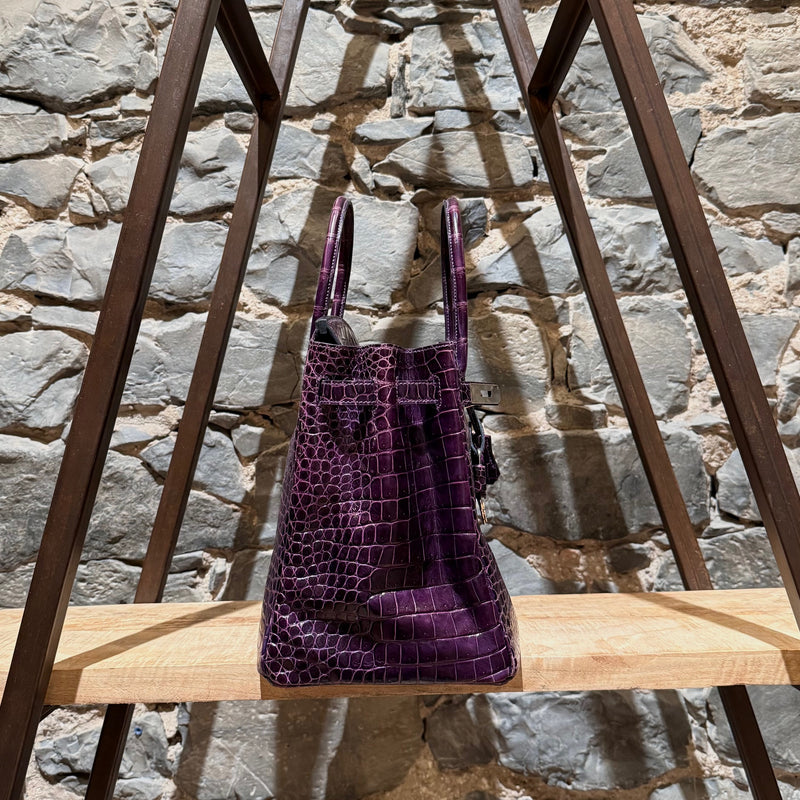 Side angle of Hermès 2014 Amethyst Shiny Porosus Crocodile Birkin 35 Bag highlighting its rolled leather handles