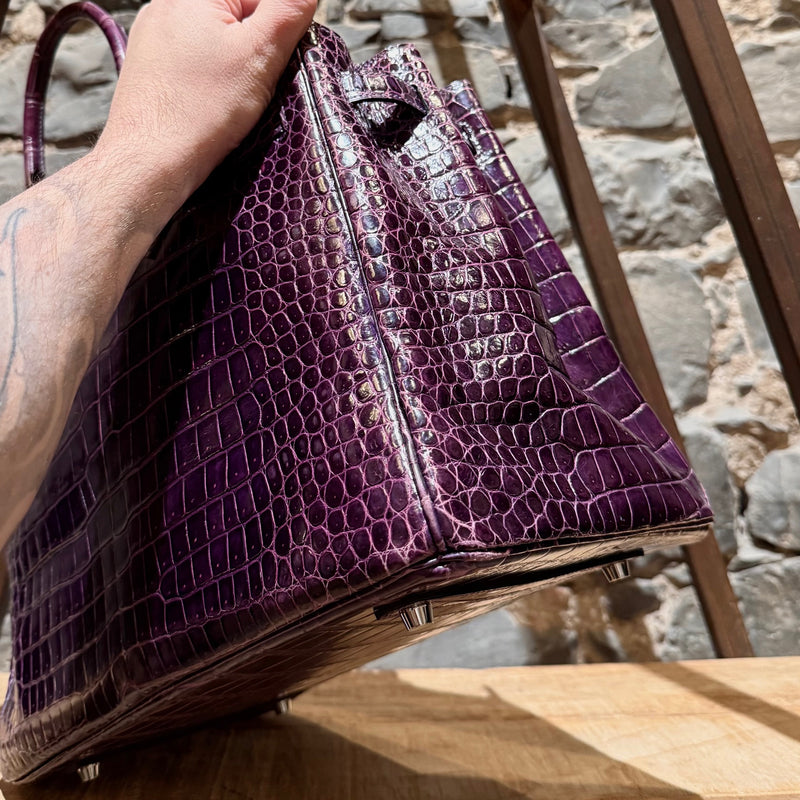 Side angle of Hermès 2014 Amethyst Shiny Porosus Crocodile Birkin 35 Bag highlighting its rolled leather handles