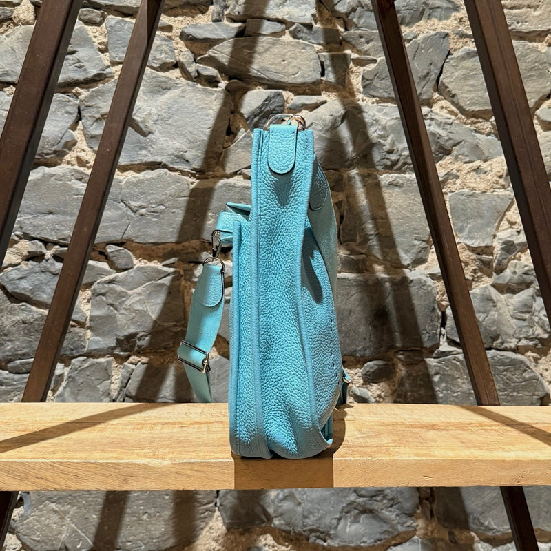 A side view of Hermès 2015 Bleu Atoll Clemence Evelyne III Crossbody Bag